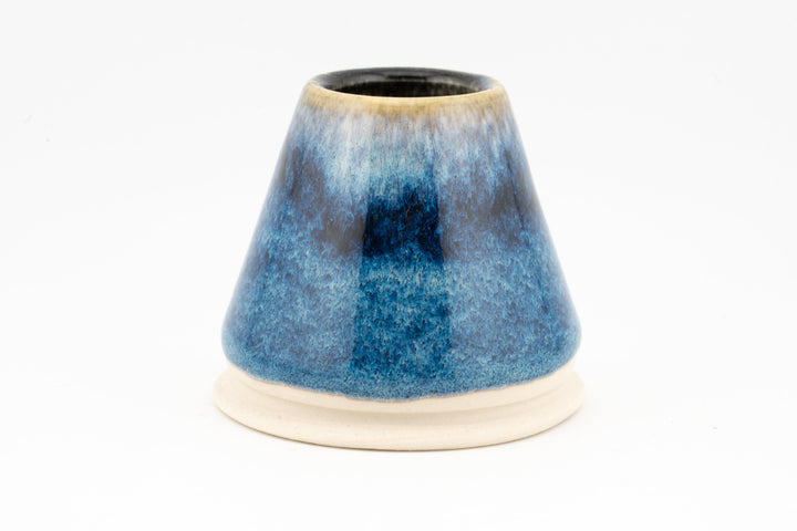 Blue ceramic matcha bowl with tapered shape and thick glaze, no whisk holder shown