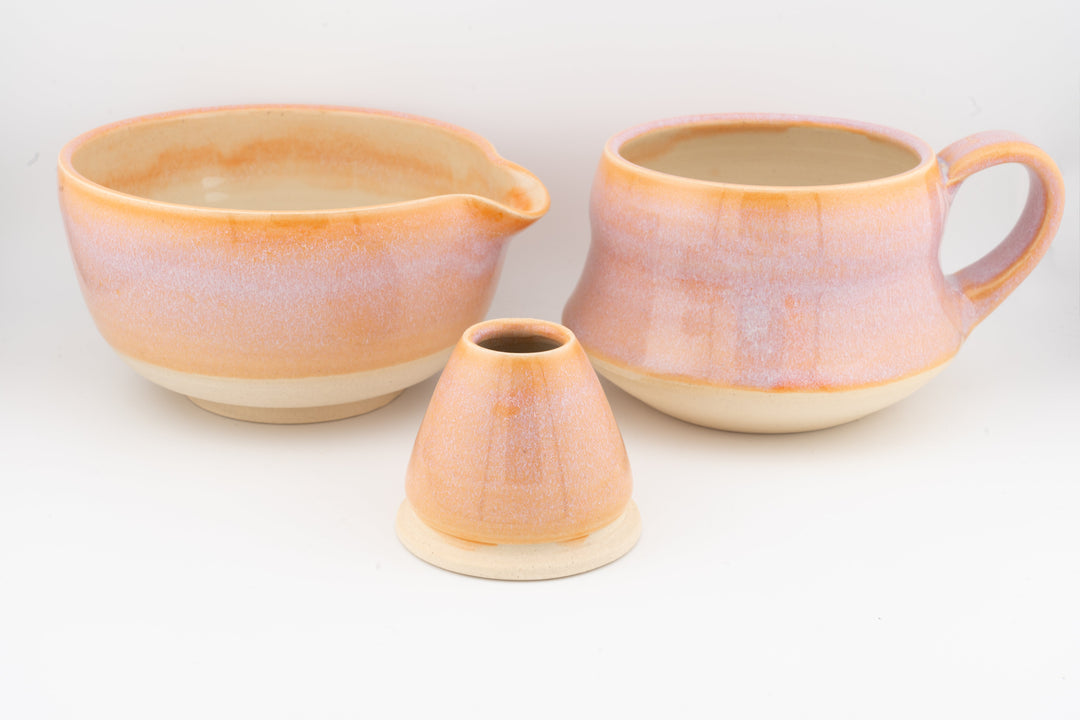 Orange ceramic matcha bowl (chawan) set with two handle mugs and a small spouted cup