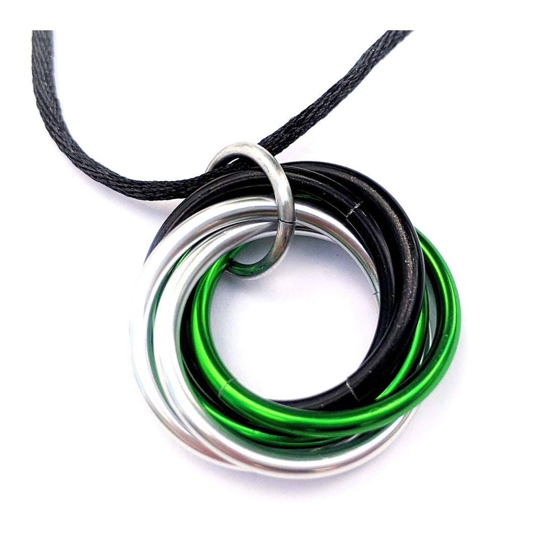 Multiring fidget necklace with black cord and green-silver iridescent hoop pendant