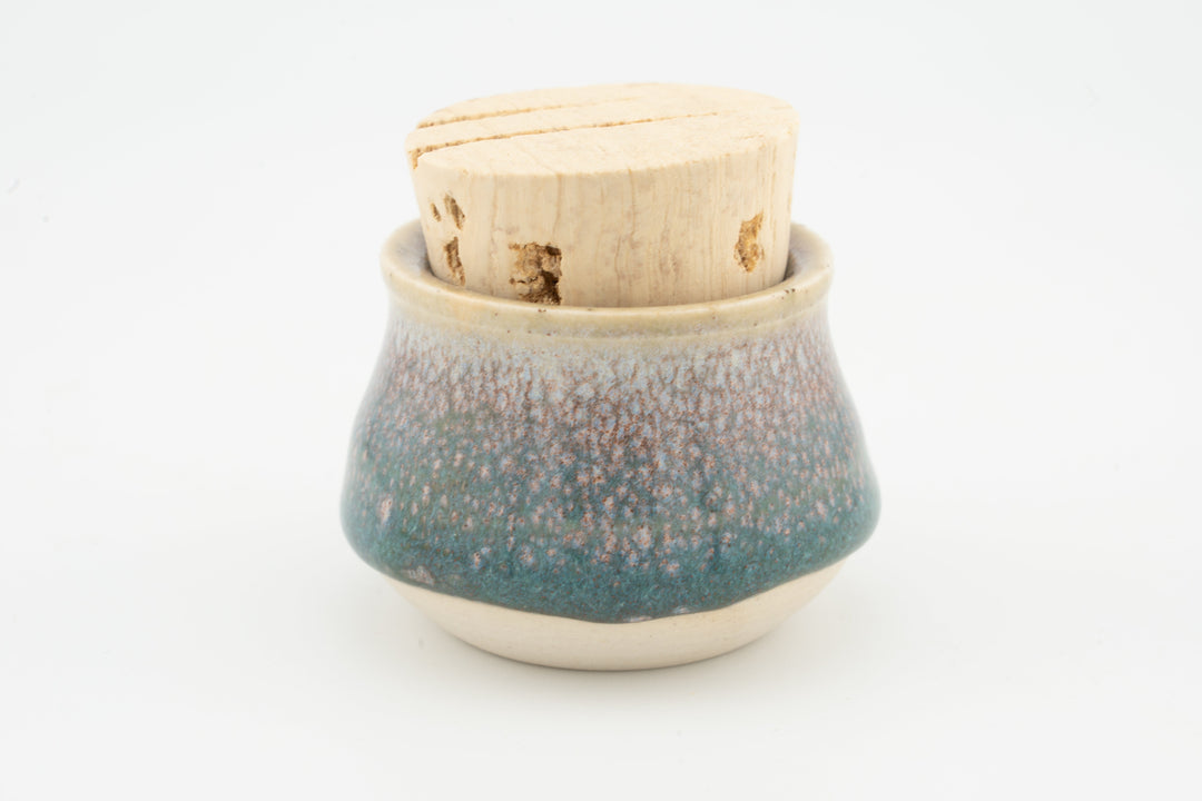 Mini corked jar with teal blue speckled ceramic glaze and cork lid.