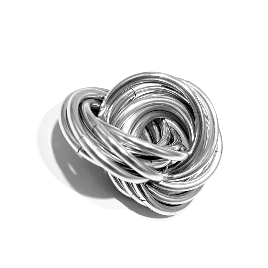 Swirled metallic fidget stress ball, chrome-like silver loops with a hollow center