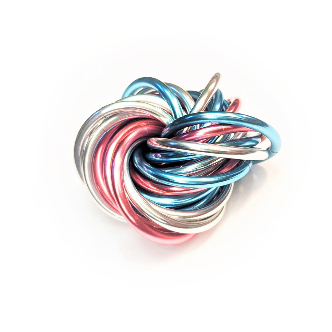 Multicolor metal fidget ball toy with silver, blue, and pink coils and silver connector prongs