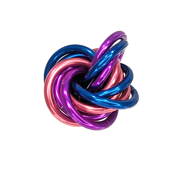 Shiny multicolor fidget stress balls in a clear cup with purple, pink, blue, and teal coils