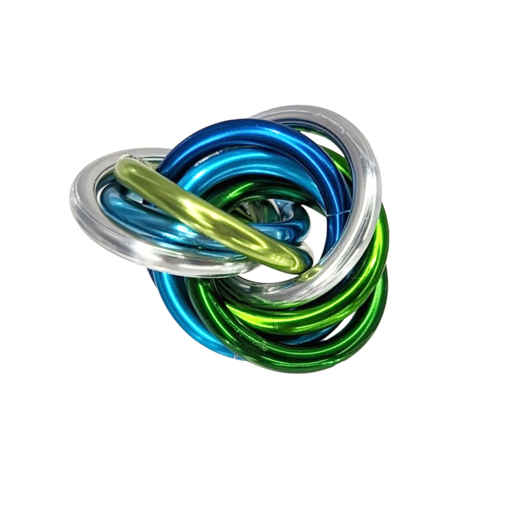 Shiny multicolor fidget stress balls in a clear cup with blue, green, and gold coils
