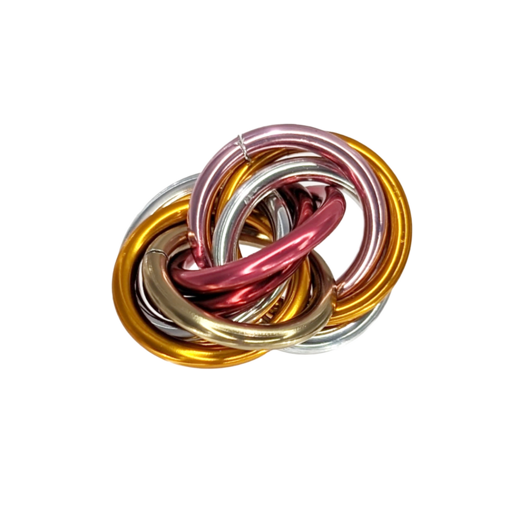 Shiny multicolor fidget stress balls in a clear cup with yellow, silver, pink, and red coils