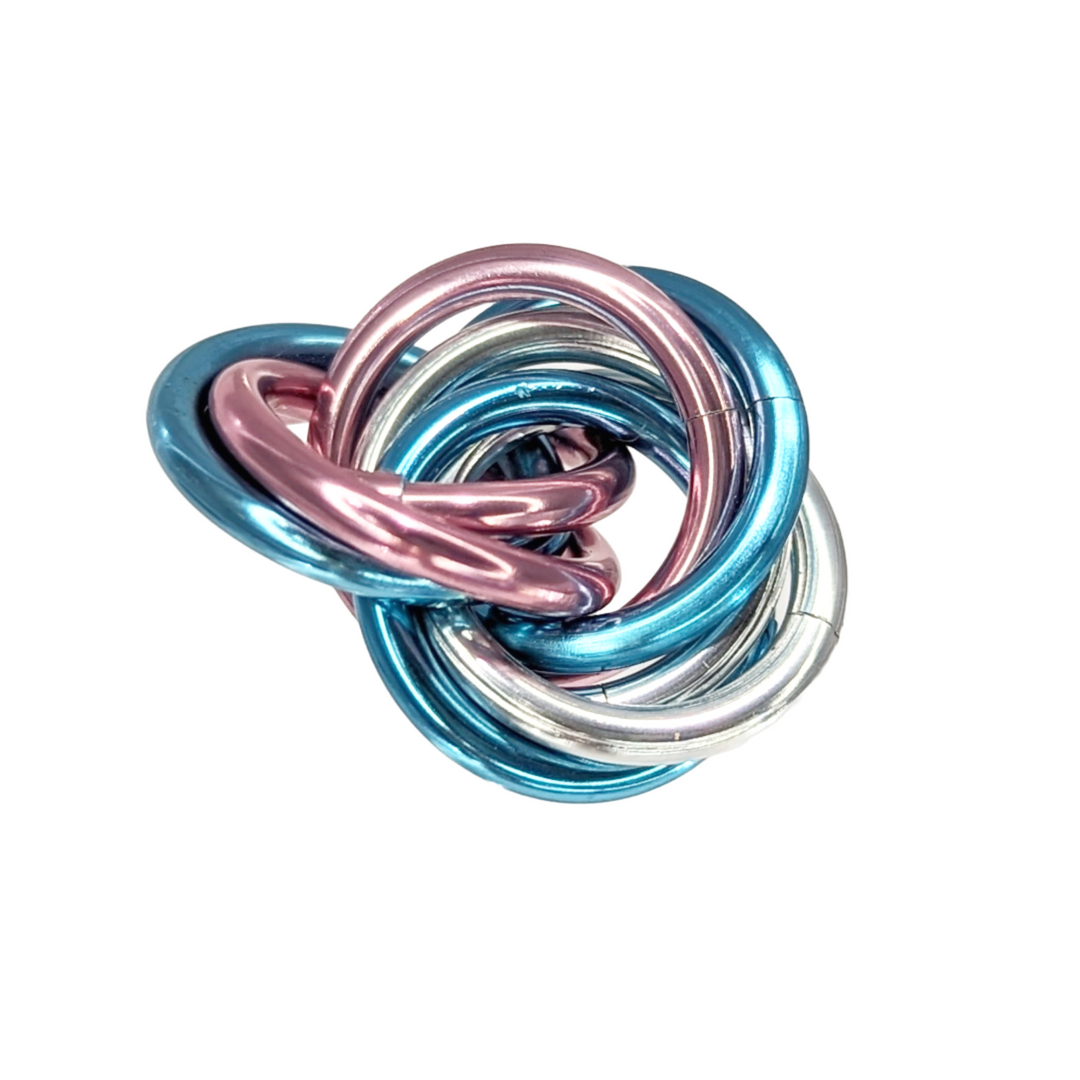 Shiny multicolor fidget stress balls in a clear cup with blue, teal, pink, and silver coils