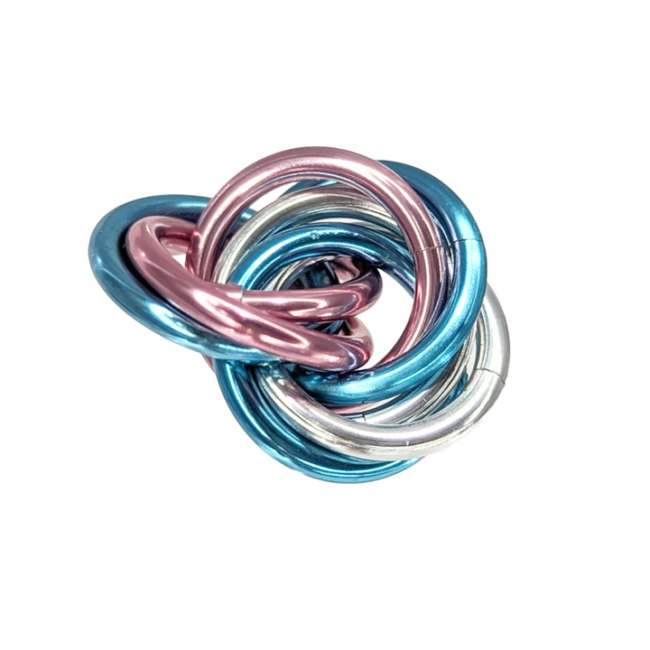 Shiny multicolor fidget stress balls in a clear cup with blue, teal, pink, and silver coils