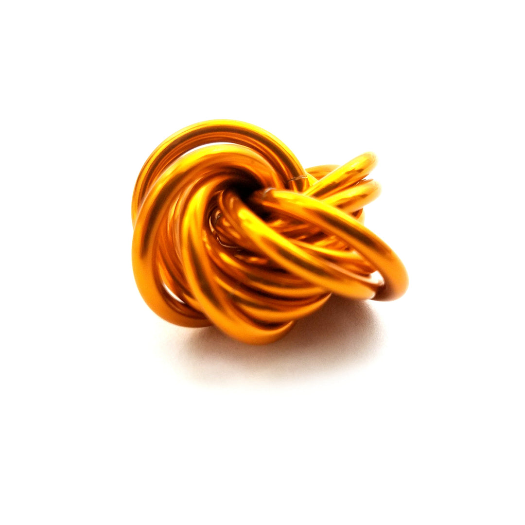 Orange stress fidget ball with a twisted knot design.