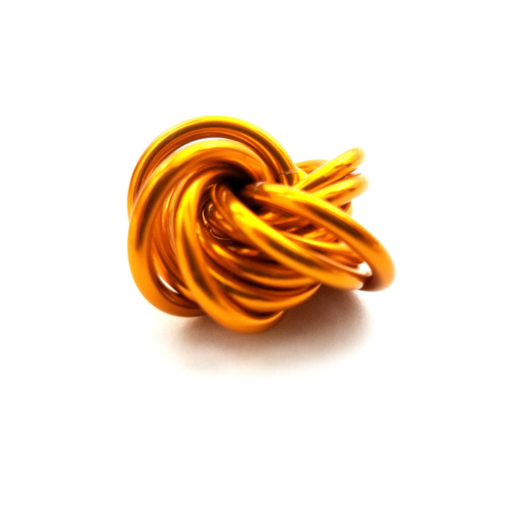 Orange stress fidget ball with a twisted knot design.