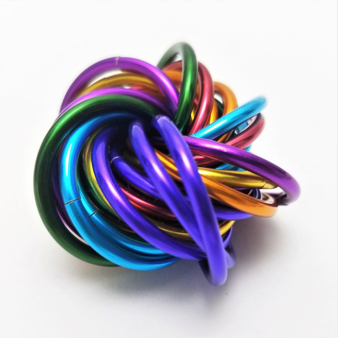 Shiny multicolor ring fidget stress ball with overlapping purple, green, blue, and orange rings