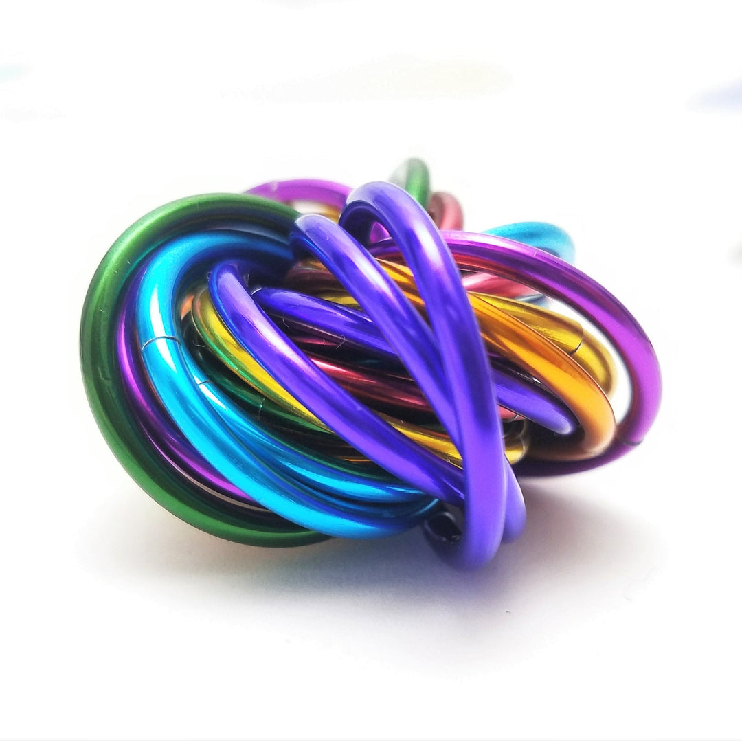 Shiny multicolor ring fidget stress ball, rainbow metallic rings stacked in a knot