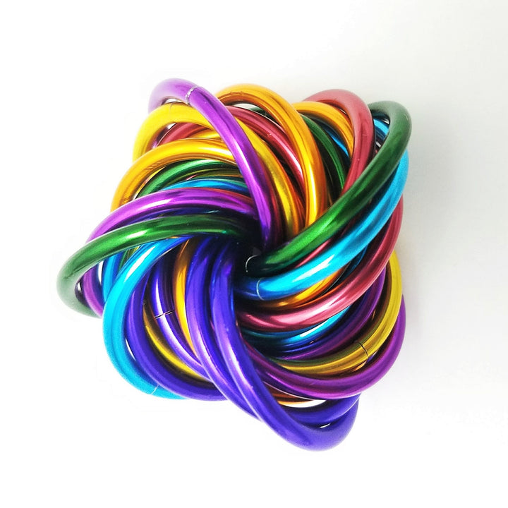 Shiny multicolor ring fidget stress ball with golden, green, blue, and purple rings