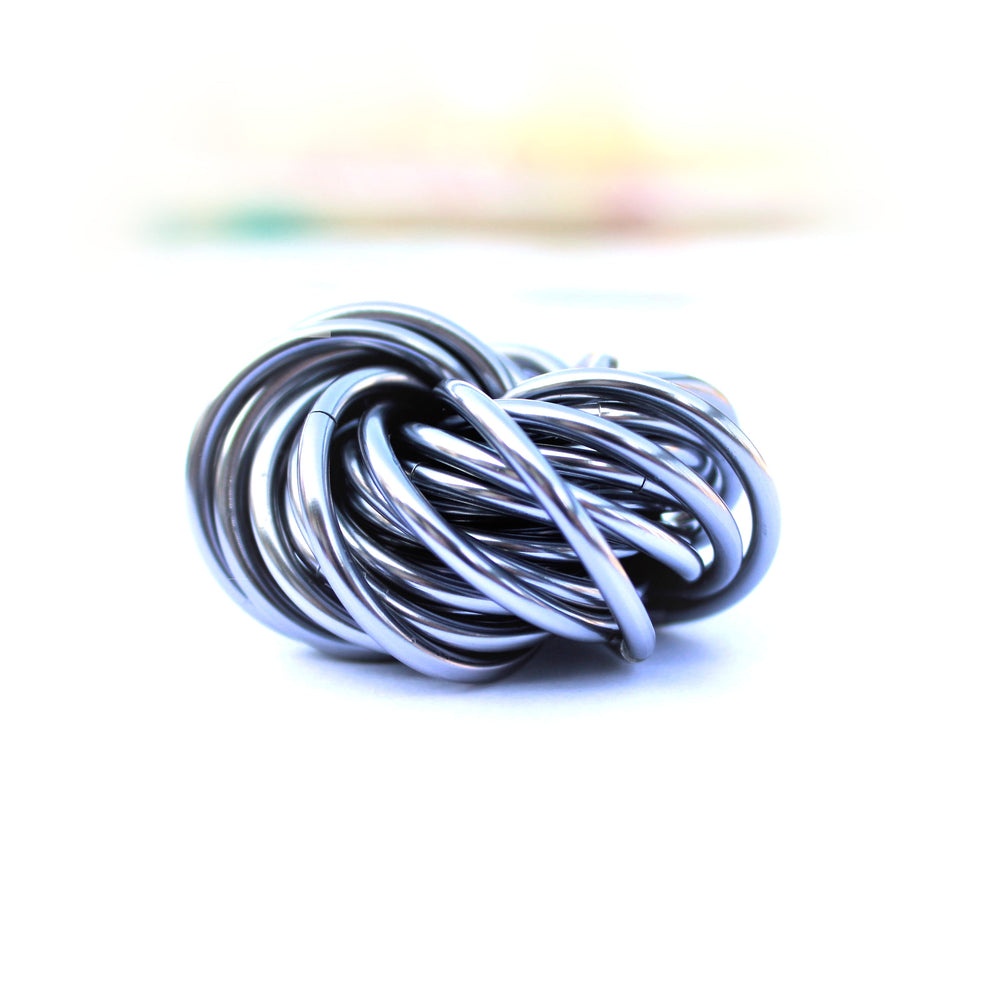 Silver-blue metallic stress fidget ball with coiled loop design