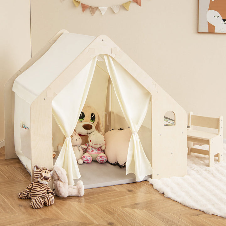 Beige toddler playhouse tent with white canopy curtains and plush toys inside