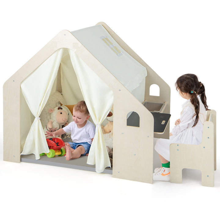 Beige playhouse with white curtains, chalkboard panel, and child-sized chair with bin