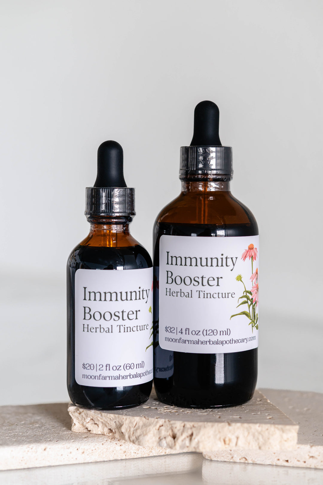 Amber herbal tincture dropper bottles with front labels and stainless caps