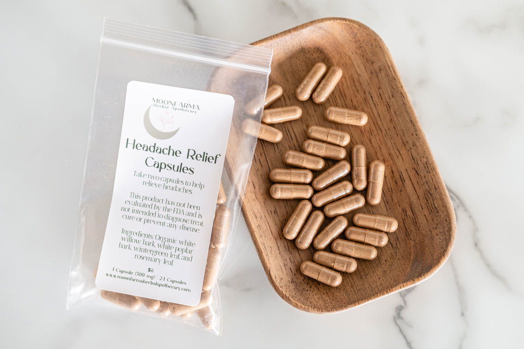 Headache relief capsules in clear pouch with wooden scoop of beige gelatin capsules