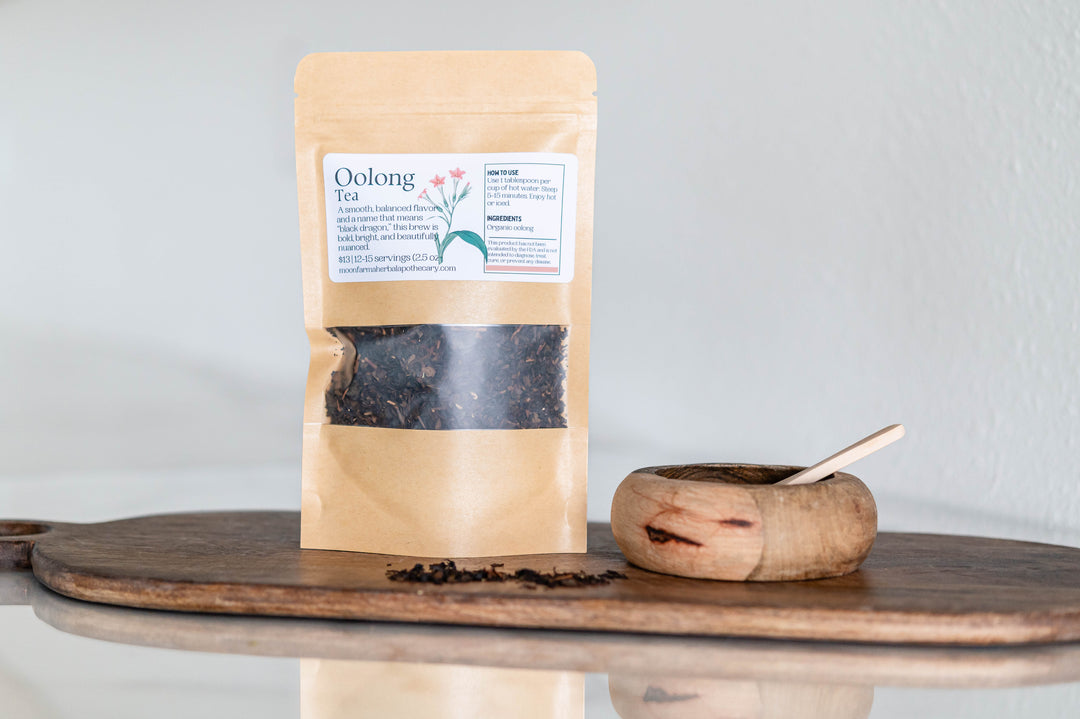 Oolong tea pouch with loose tea leaves and wooden scoop
