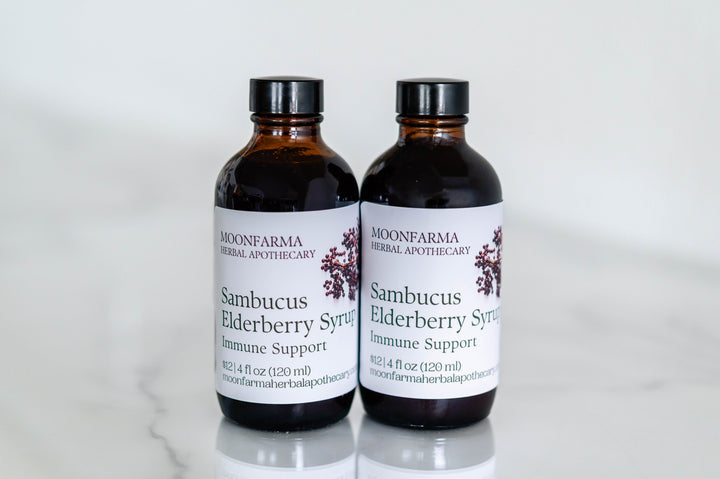 Sambucus elderberry syrup bottles, Moonfarma labels, dark amber glass, two-pack