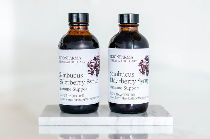 Moonfarma Sambucus elderberry syrup bottles, dark amber glass, two-pack on display
