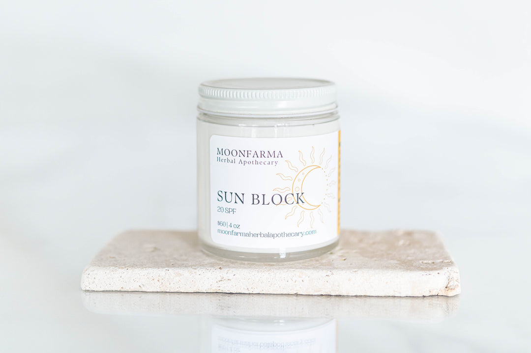 Sunscreen lotion jar with SPF label, clear lid and light cream-colored label