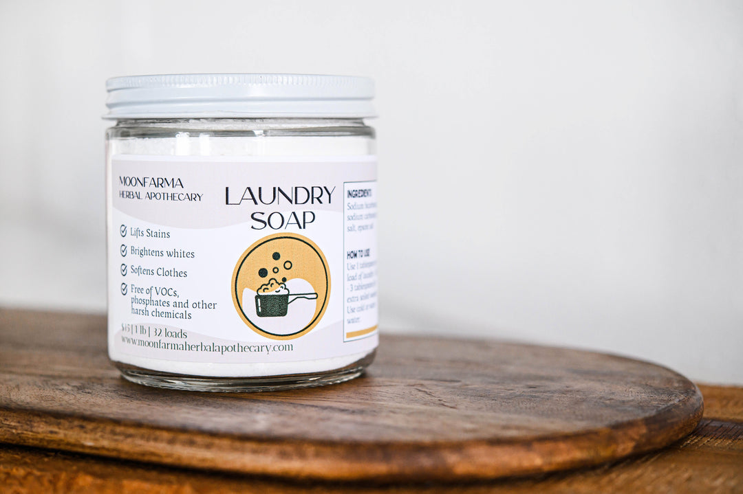 Laundry soap jar with white lid, front label with small icons and text