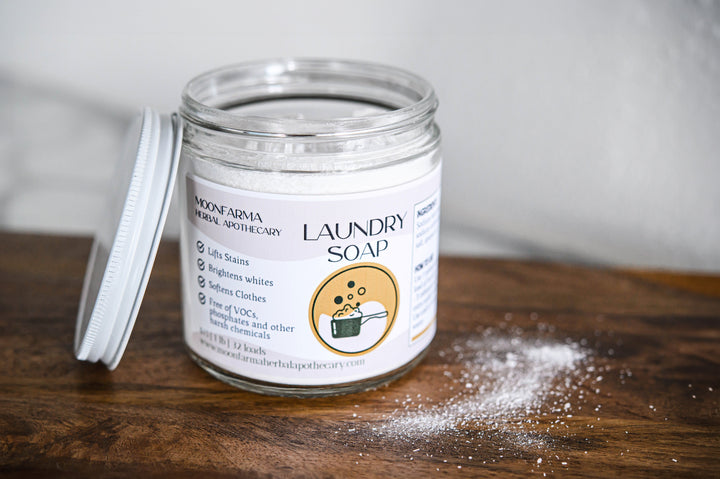 Laundry soap jar with open white lid, front label visible