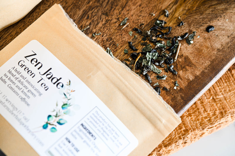 Loose green tea leaves in resealable kraft pouch with teal product label