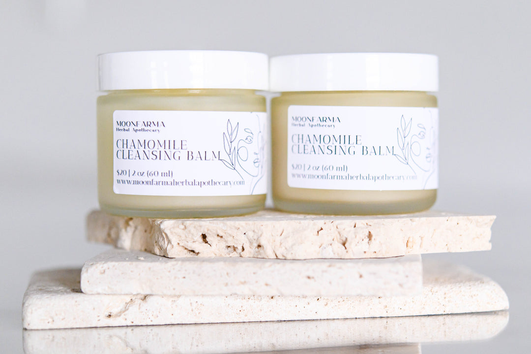 Chamomile cleansing balm jars with white caps, pale green balm