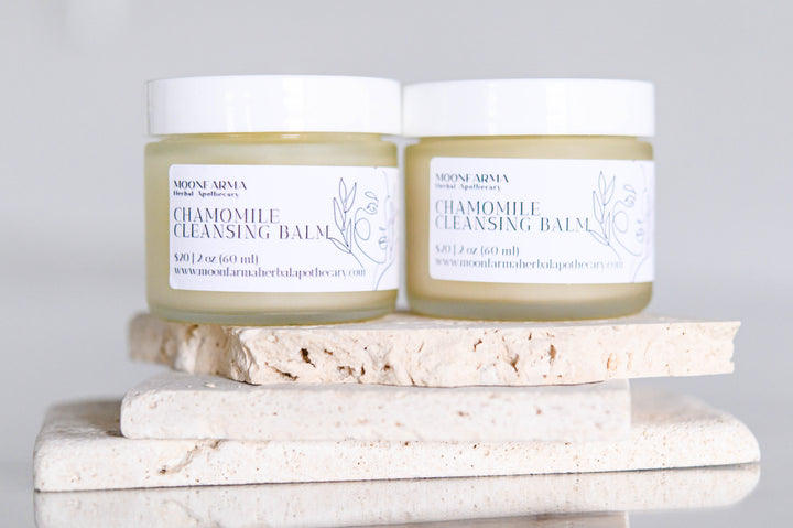 Chamomile cleansing balm jars with white caps, pale green balm