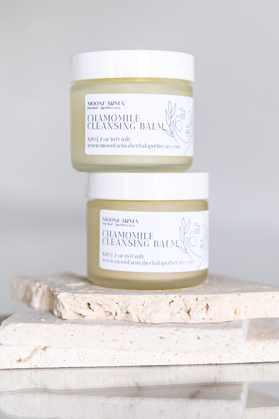 Chamomile cleansing balm facial cleanser jar with white cap, pale green balm