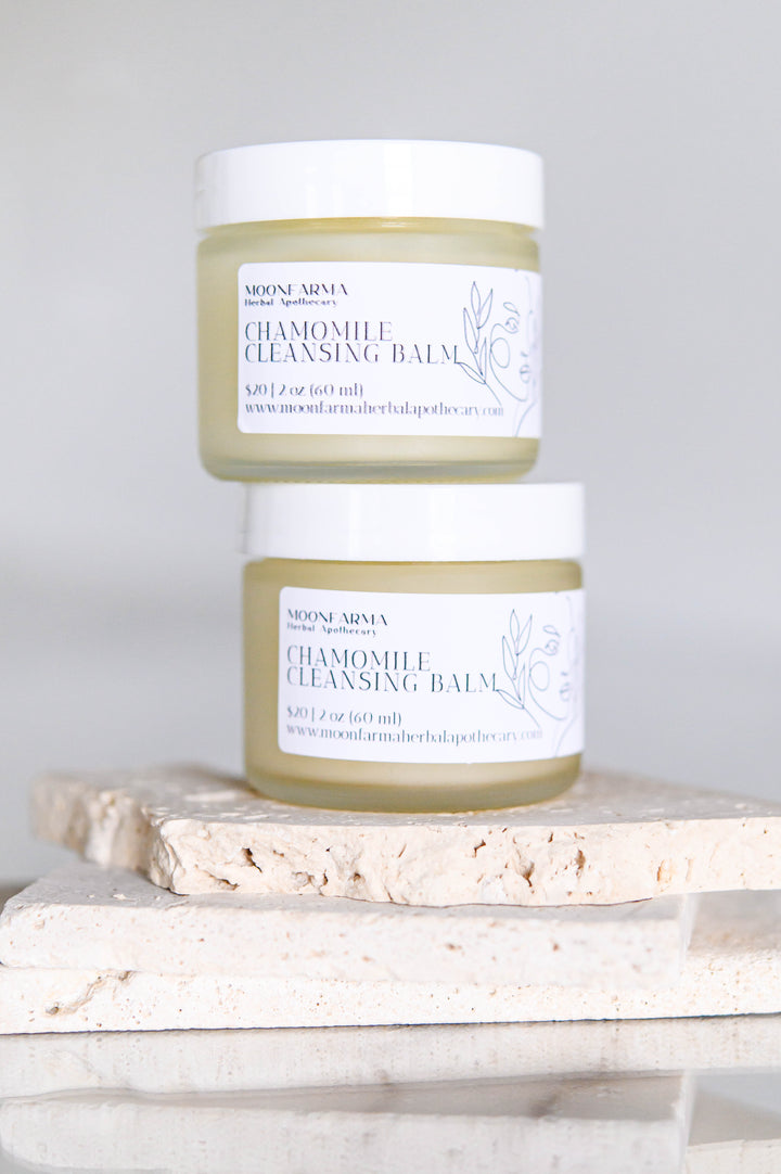 Chamomile cleansing balm facial cleanser jar with white cap, pale green balm