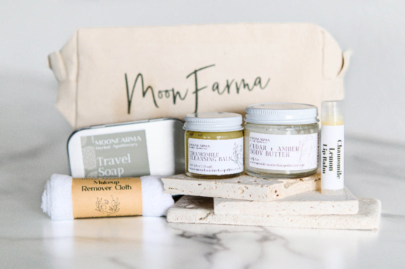 Essentials travel kit with beige pouch, travel soap, cloth, and body care jars