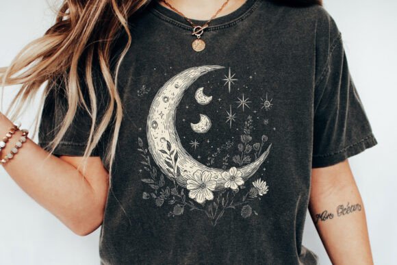 Close-up dark T-shirt with crescent moon, stars, and white floral boho graphic