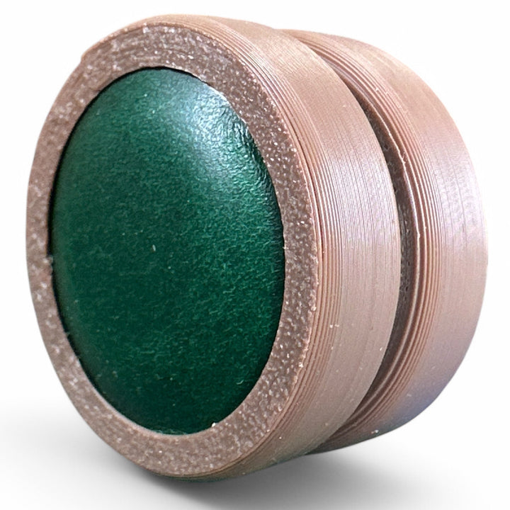 Brown fidget moon toy with dark green oval center, two stacked rings
