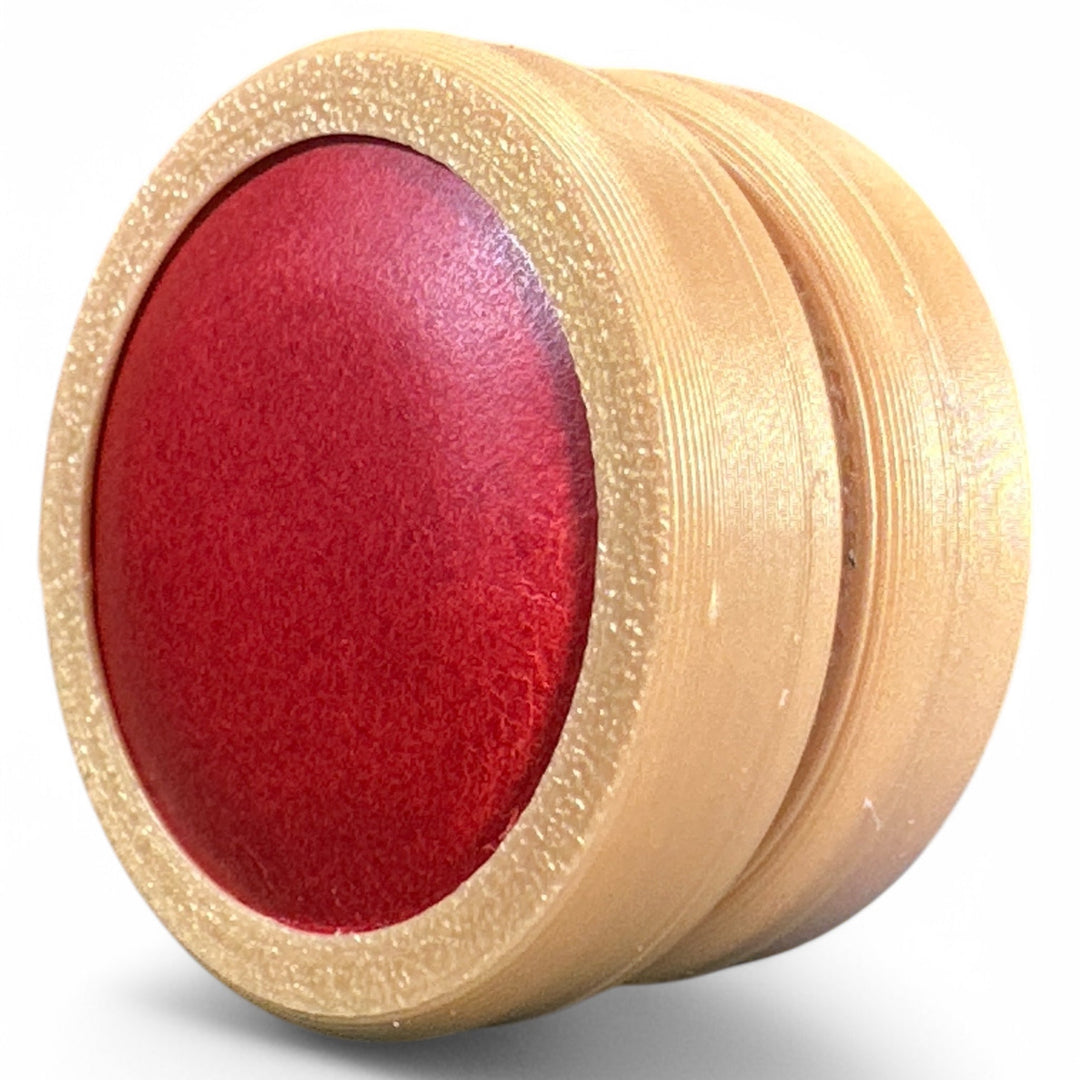 Beige fidget moon toy with red oval center, two stacked rings
