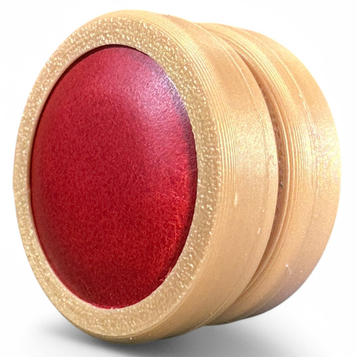 Beige fidget moon toy with red oval center, two stacked rings