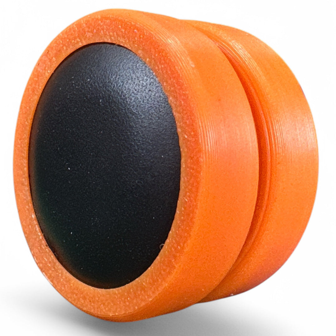 Orange fidget moon toy with dark oval center, two stacked rings