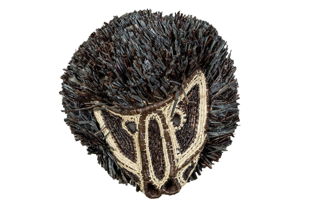 Black and white colobus monkey mask with dark shag fringe and cream face embroidery
