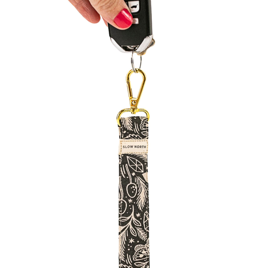 Gold key ring with black patterned wristlet keychain charm featuring cosmic mushroom design
