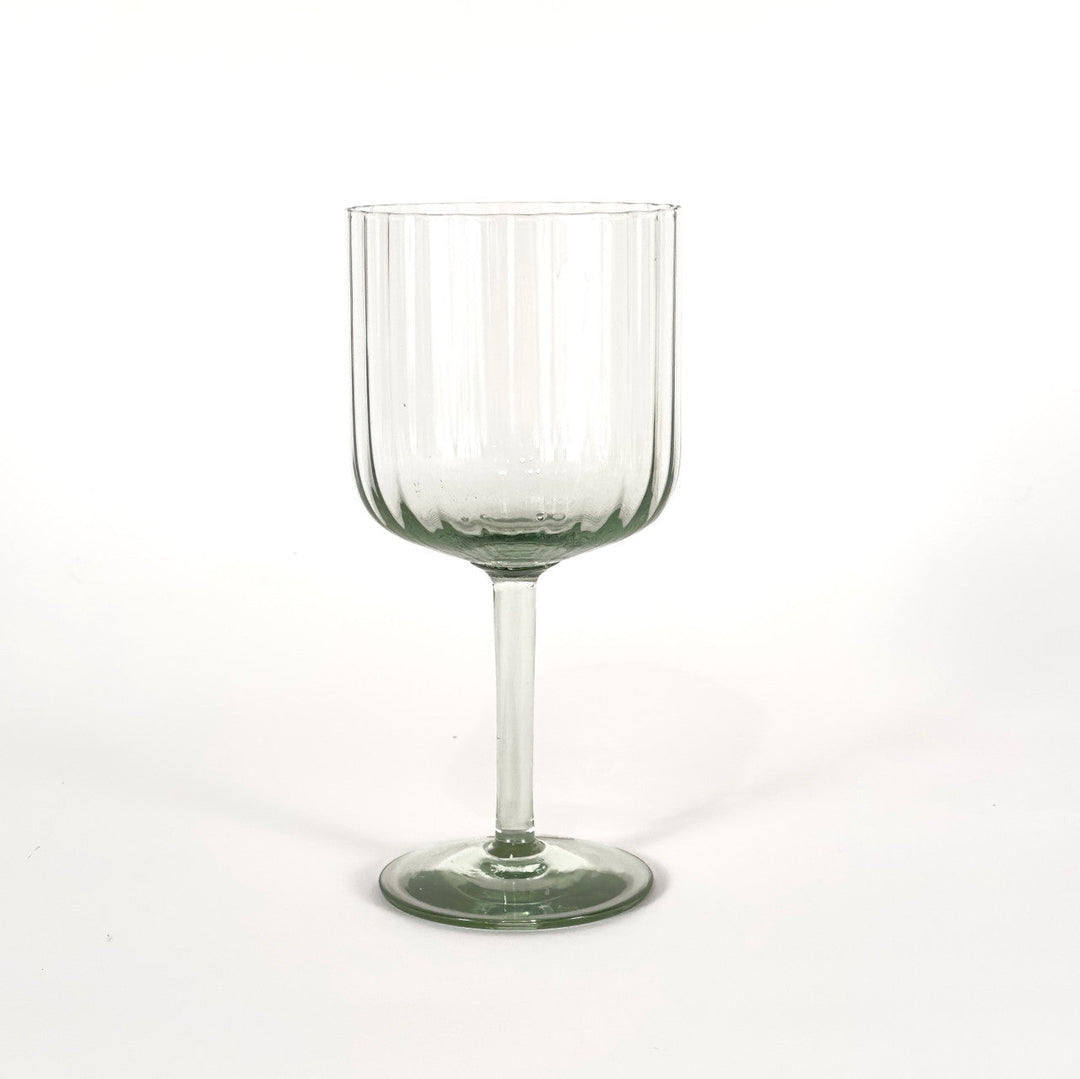 Retro optic wine glass with ribbed bowl and short clear stem, green-tinted base