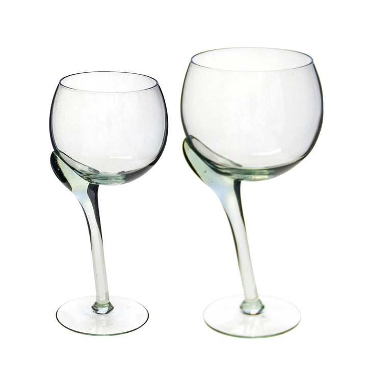 Pair of crooked-stem wine glasses with green-tinted glass bowls and round bases.