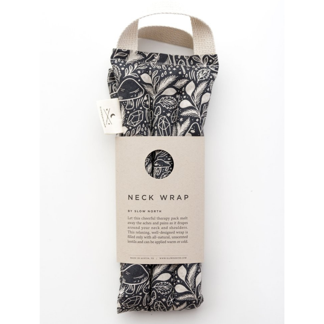 Packaged neck wrap with black-and-white mushroom pattern, cream straps, and Neck Wrap label
