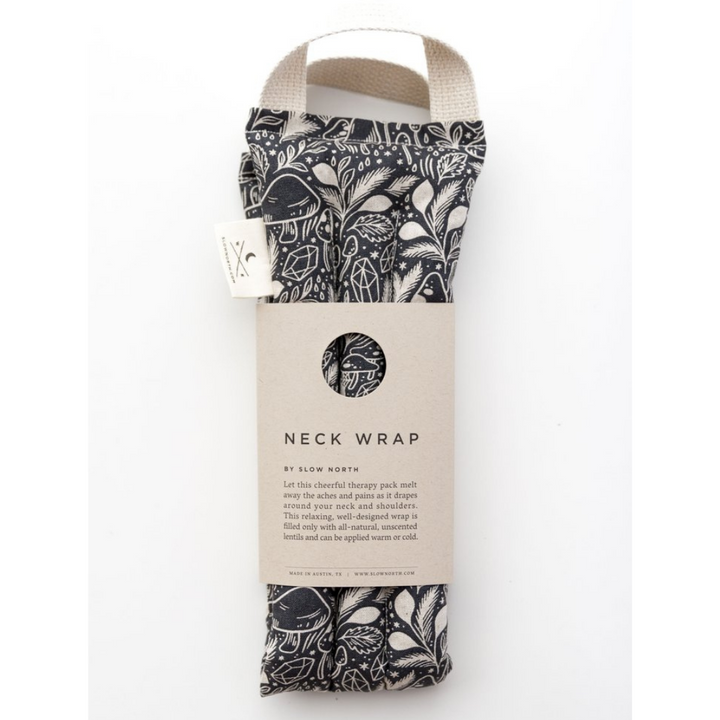 Packaged neck wrap with black-and-white mushroom pattern, cream straps, and Neck Wrap label