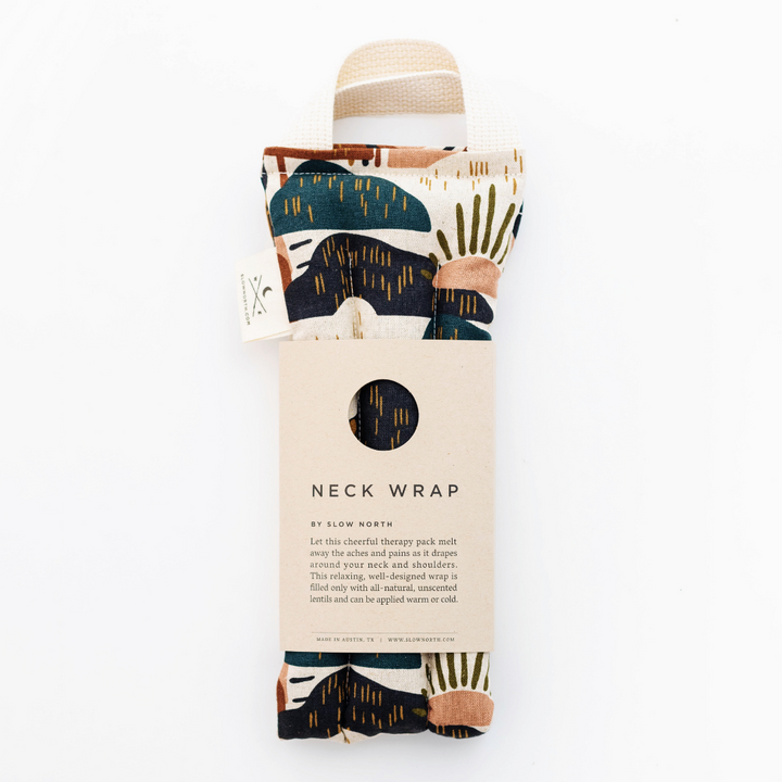 Folded beige neck wrap with multicolor abstract print and circular label