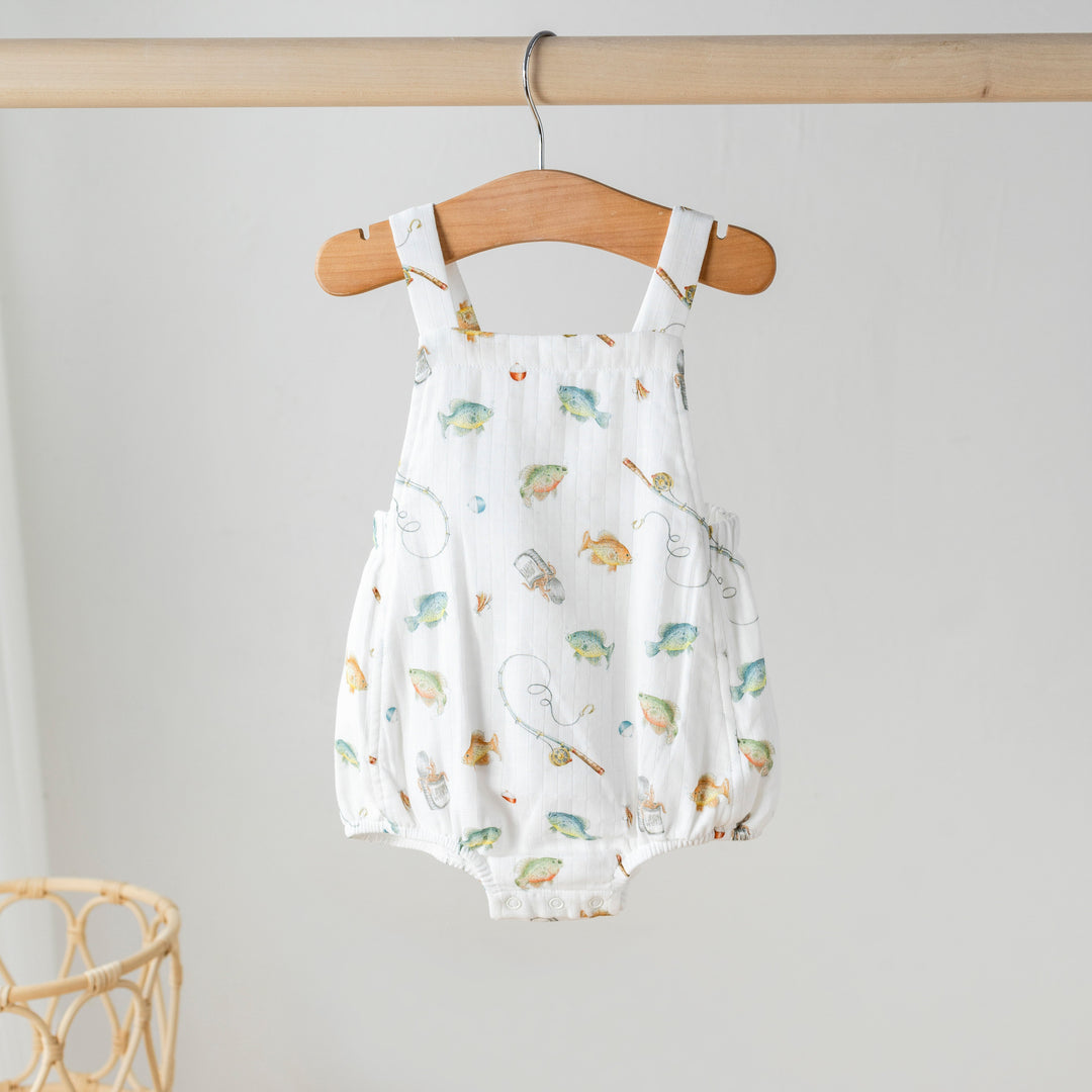 White organic muslin bubble shortall with colorful animal print, snap legs
