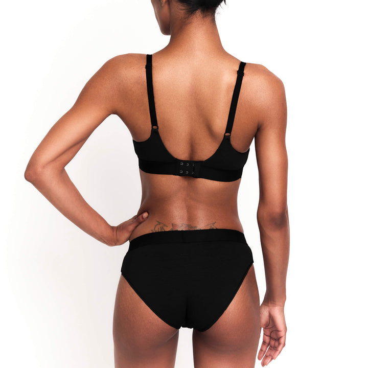 Black mid-rise brief from the back with seamless fit and high-cut leg openings.