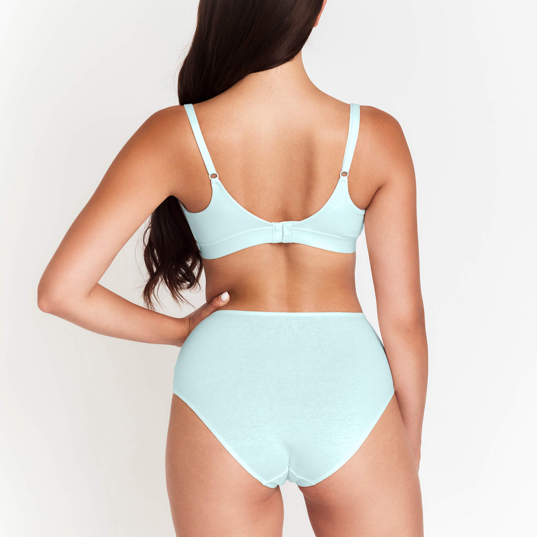 High-rise brief in light blue with high waist and full back coverage, worn on model.