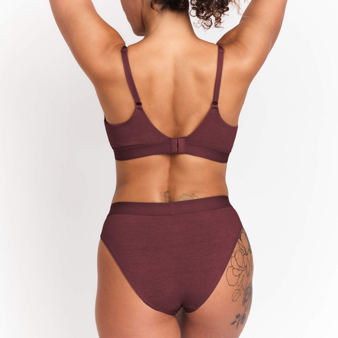 Burgundy mid-rise brief back view with wide waistband and smooth full-coverage fit.