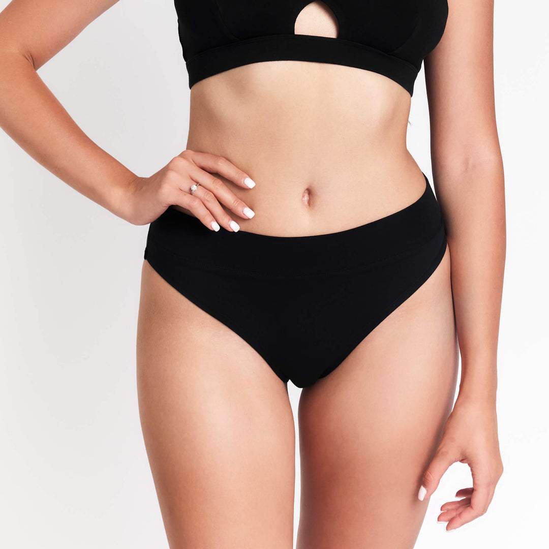 Black high-rise cheeky tanga underwear with narrow waistband and full side view